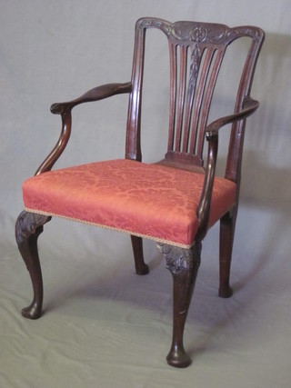 A 19th Century mahogany open arm carver chair with  upholstered seat and vase shaped back, raised on cabriole supports