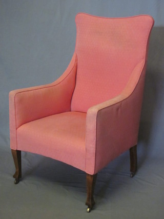 An Edwardian mahogany framed armchair upholstered in pink material and raised on square tapering supports