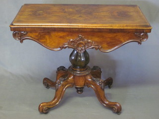 A William IV figured walnut tea table, raised on a turned column  and tripod base 35"