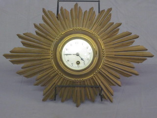 A French wall clock with silvered dial contained in a carved  wooden sunburst case