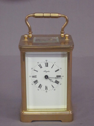 A 20th Century carriage clock with enamelled dial and Roman  numerals contained in a gilt metal case by Angelus   ILLUSTRATED