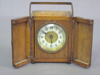 A 19th Century travelling clock with enamelled dial and Arabic  numerals contained in a walnut case