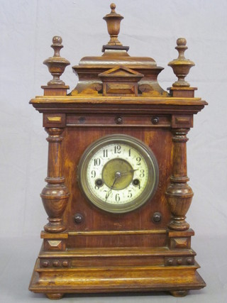 An American 8 day striking bracket clock with enamelled dial  and Arabic numerals contained in an oak case