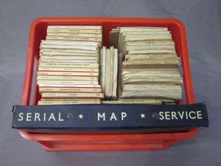 A red plastic crate containing a collection of Ordnance Survey  maps
