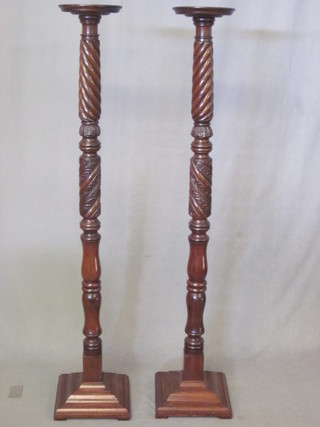 A pair of 19th Century mahogany bed post torcheres
