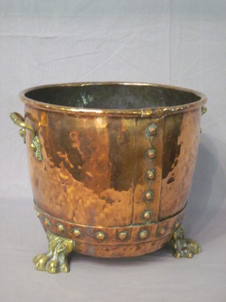 A twin handled circular copper and brass coal bin with paw feet  14"