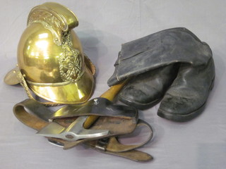 A brass reproduction fireman's helmet together with a fireman's  axe and a pair of leather boots