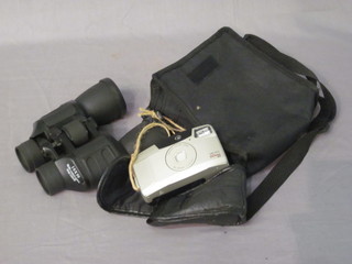 A pair of 10 x 50 binoculars together with a Canon Sure Shot camera