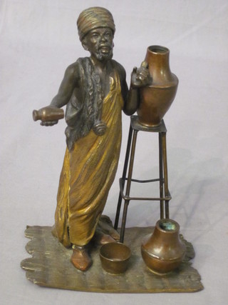 A bronze figure of a standing pot vendor 7"   ILLUSTRATED