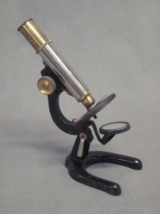 A student's brass and chrome single pillar microscope contained  in a fibre case