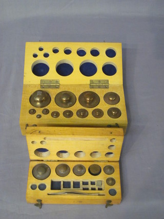 2 rectangular wooden boxes containing brass weights