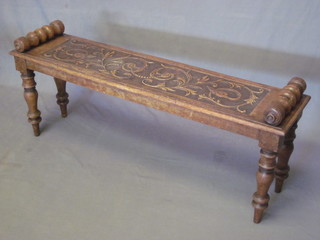 A Victorian rectangular oak hall bench with carved panel to the top, raised on turned supports 48"