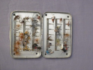 A rectangular aluminium fly box and contents of flies 3 1/2"