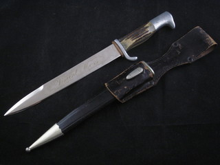 A German hunting knife with 8" blade and staghorn grip, contained in a leather scabbard