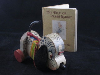 A childs wooden Fisher Price pull-a-long toy dog no.445 and 1 edition of Beatrix Potter "Tales of Peter Rabbit"
