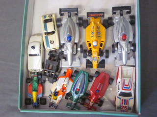 A collection of tin plate model cars and other model racing cars