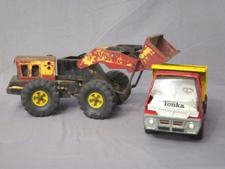 A Tonka tip up truck and an earth moving machine