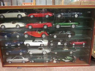 A mahogany and glazed display cabinet containing 18 various model cars