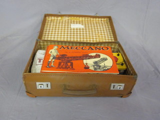 A small attache case containing a collection of Meccano