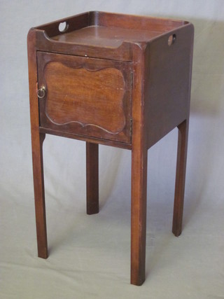 A Georgian style mahogany tray top bedside cabinet enclosed by  a panelled door, raised on square tapering supports 14"