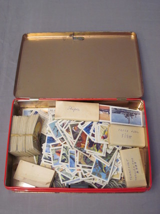 A tin containing various tea cards