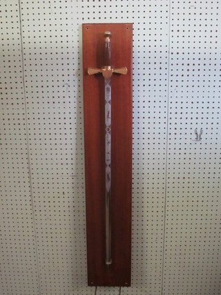 A Wilkinson Sword sword, the 30" blade etched cricketing  scenes