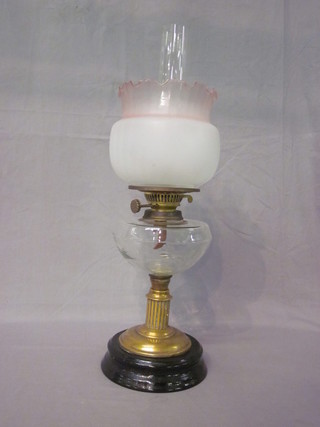 A Victorian glass oil lamp reservoir raised on a reeded brass  column