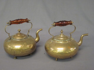 2 circular brass kettles with amber glass handles