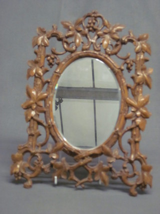 A 19th Century oval plate wall mirror contained in a pierced and  carved frame 13"