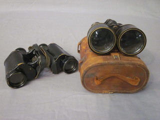 A pair of 6x field glasses and a pair of War Office issue binoculars contained in a leather carrying case