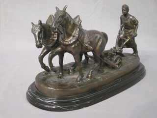 A bronze figure of a pair of horses with plough 14", raised on an oval base