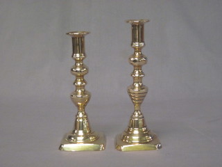 A pair of 19th Century brass candlesticks with ejectors and  knopped stems 9"