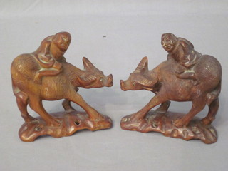 A pair of Eastern carved wood figures riding Buffalo 4"