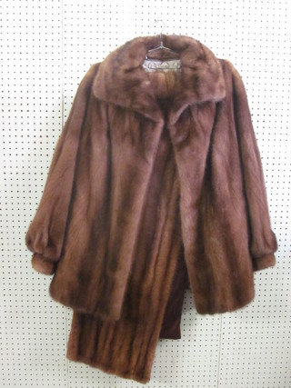 A lady's mink stole together with a mink coat