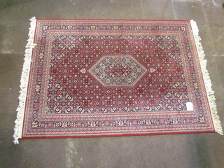 A red ground Persian style machine made carpet 91 1/2" x 67"