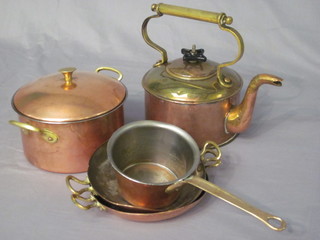 A brass kettle, a twin handled saucepan and cover, a saucepan  and 2 circular dishes