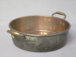 A copper twin handled preserving pan