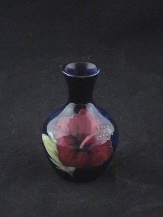 A Moorcroft blue ground club shaped vase decorated Hibiscus,  the base with paper label Potter to the Queen, 4"   ILLUSTRATED
