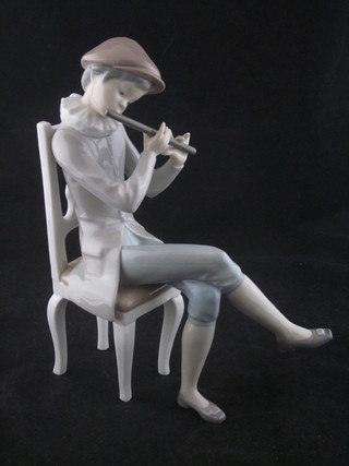 A Lladro figure of a seated boy with flute, finger f, 9"