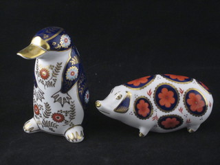 A Royal Crown Derby porcelain figure of a standing penguin  base marked LVI together with a pig base marked LVII, both  seconds, 5"