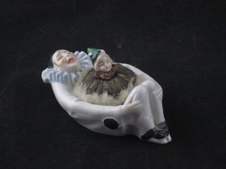 A porcelain powder puff in the form of a reclining Pierrot 5"