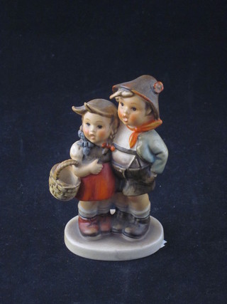 A Goebel figure of a standing boy and girl, girl with basket 4", base impressed 94/30