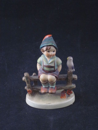 A Goebel figure of a seated boy with bird, base impressed 1938  3"