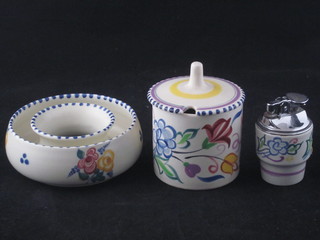 A circular Poole Pottery preserve jar and cover 2", a circular  flower ring 4" and a Poole Pottery table lighter