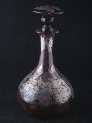 A Victorian cranberry club shaped decanter and stopper with  silver overlay decoration 10"