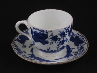 A porcelain cup and saucer with blue Oriental design, the base  with stylised character marks