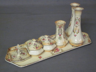 An Edwardian 8 piece pottery dressing table set comprising rectangular tray, pair of candlesticks, pair of lozenge shaped  trinket boxes and covers, ring tree and hat pin stand
