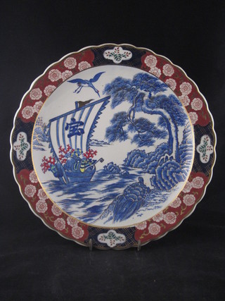 A Japanese Imari circular porcelain charger decorated a boat within gilt banding, some crazing, 14"