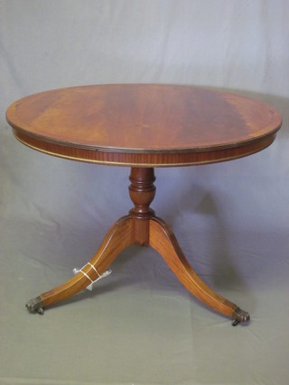 A Georgian style circular mahogany breakfast table, raised on a  pillar and tripod base 42"