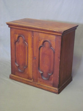A Victorian cedar cigar cabinet with moulded cornice enclosed  by a pair of panelled doors 24"